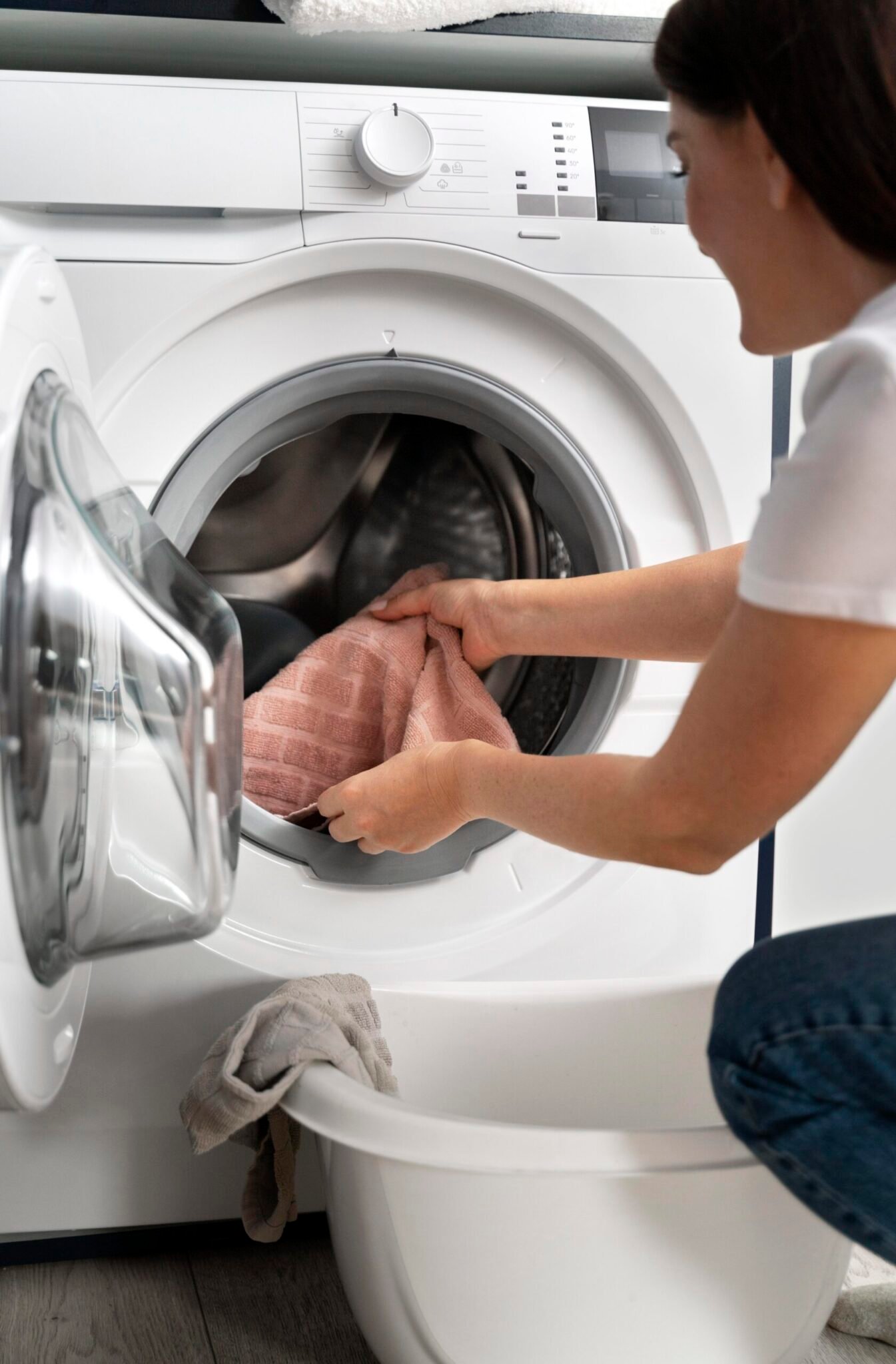 woman-taking-clothes-from-washing-machine