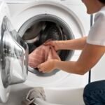 woman-taking-clothes-from-washing-machine