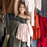 young-woman-surrounded-by-piles-clothes